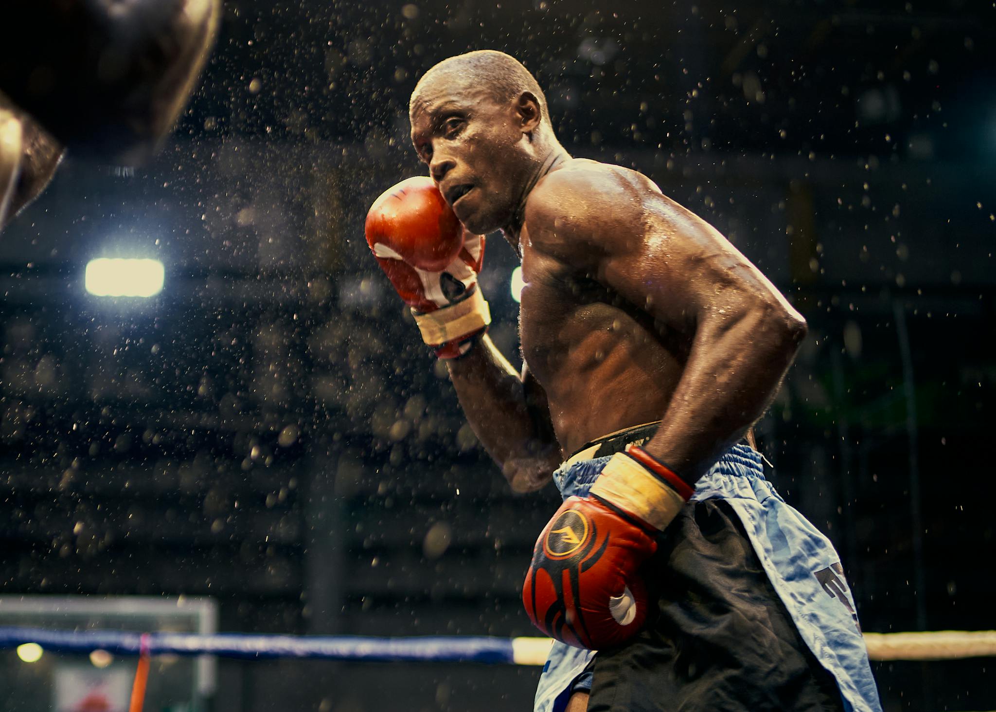 A dynamic scene of a boxer in action in a Lagos boxing ring, Nigeria.