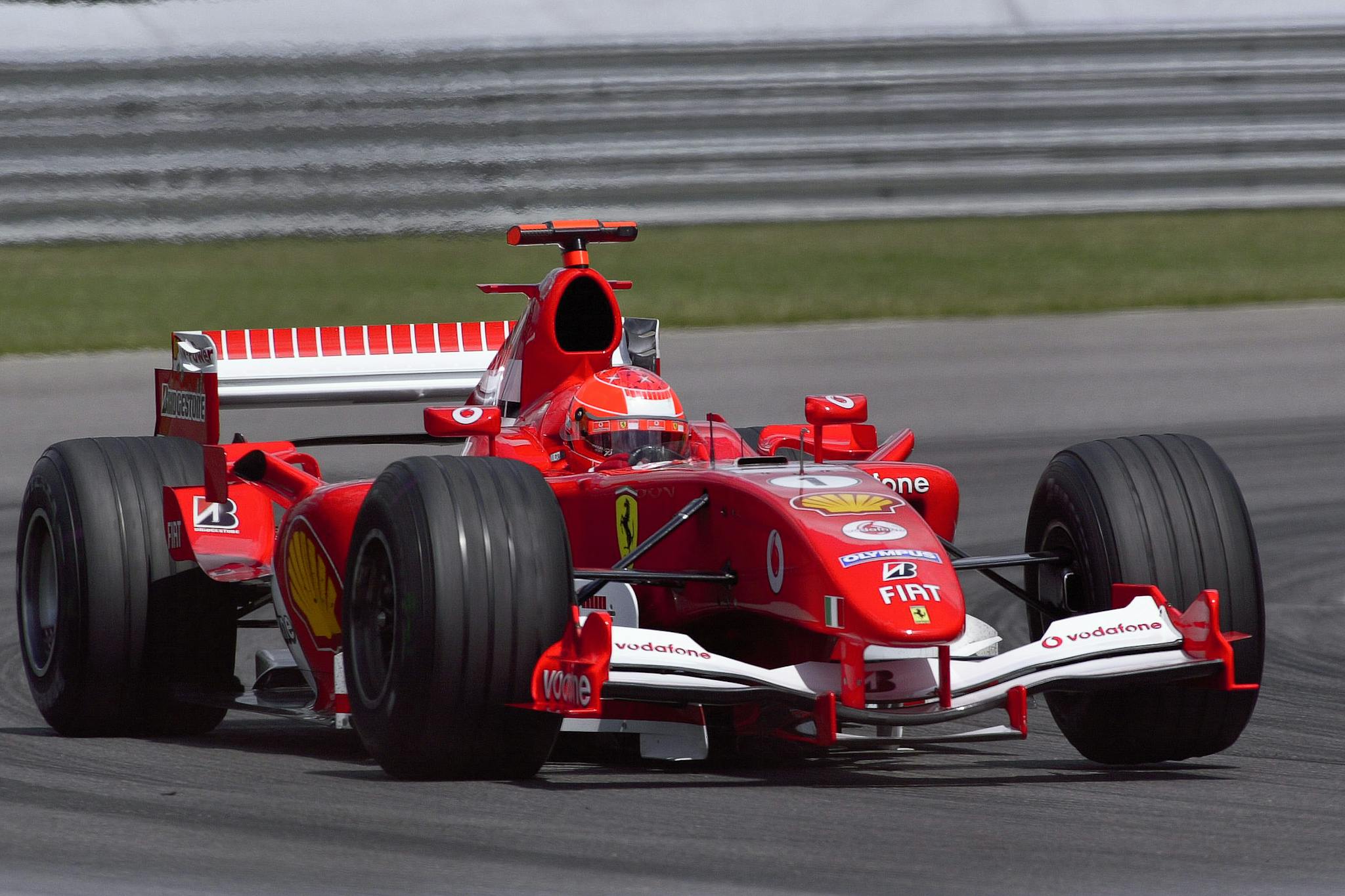 Ferrari Formula One car speeding on track at Indianapolis, showcasing performance and speed.