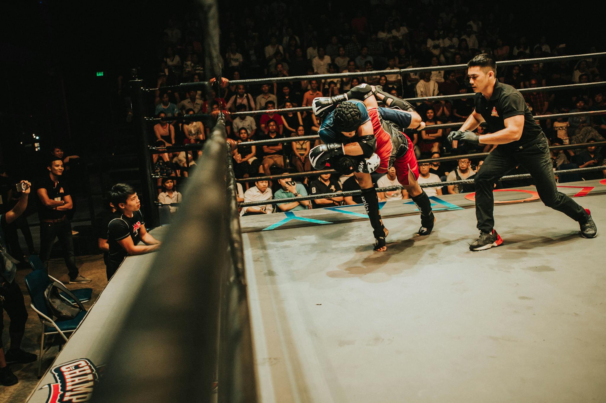 Two athletes in dynamic combat during a mixed martial arts match.