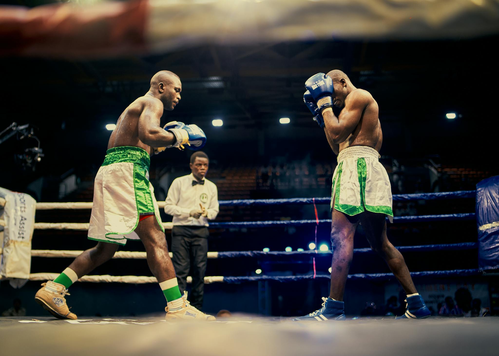 Two boxers engaged in a competitive match in Lagos, Nigeria boxing ring.